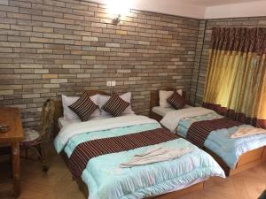 A bed or beds in a room at Lake Vision Guesthouse