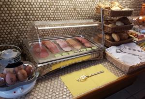 
a bakery display case filled with donuts and pastries at Hotel Garni Jägerhof in Sigmaringen
