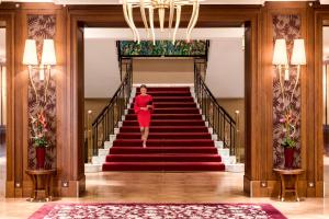 
a large staircase leading up to a large room at Grand Hotel Kempinski High Tatras in Štrbské Pleso
