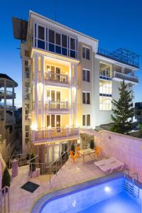 a building with a swimming pool in front of a building at Elle Hotel in Sochi