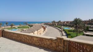 a stone wall next to a road next to the ocean at Chalet Ground floor two bedrooms With largeTerrace In Stella Di Mare sea view Ain El Sokhna for Families Only in Ain Sokhna