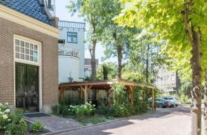 a wooden pergola on the side of a building at Wittenberg by Cove in Amsterdam +14 photos