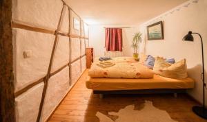 a bedroom with a bed in a room with a map on the wall at Wohnen im Denkmal in Gumperda