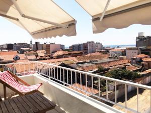 a balcony with a chair and a view of the city at Studio 177 in Matosinhos