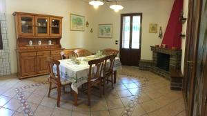 a dining room with a table and chairs and a fireplace at villamorus in Santa Maria la Palma
