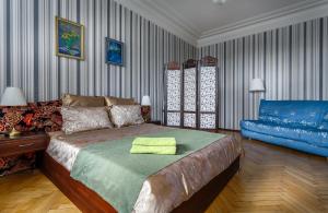 モスクワにあるАпартаменты на Плющихе 44/2のベッドルーム(ベッド1台、青いソファ付)