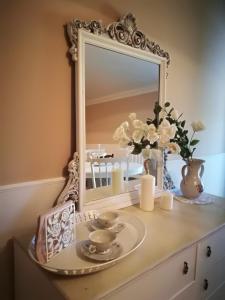 a dresser with a mirror on top of it at La Rosa Del Barone in Cancellara