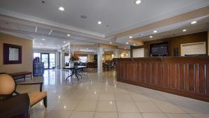 a lobby with a waiting area with a tv and a table at Best Western Plus Valdosta Hotel & Suites in Valdosta