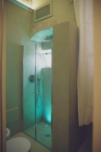 a bathroom with a glass shower with a toilet at CASA MELIO' in Polignano a Mare