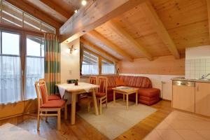 a kitchen and dining room with a table and chairs at Appartments Antoniushof in Ellmau