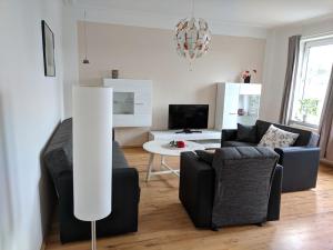 a living room with a couch and a table at Haus Gezeiten in Meldorf