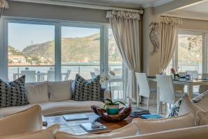 a living room with a couch and a table at Amanzi Island Boutique Hotel in Knysna