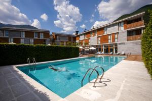 a swimming pool in front of a building at Tierra de Biescas in Biescas