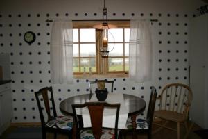 a dining room with a table and chairs and a window at Ulvsby Ranch in Karlstad