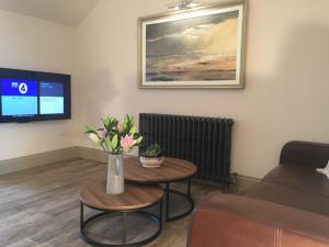 a living room with a vase of flowers on a table at Irvine One Bedroom Apartment in Irvine