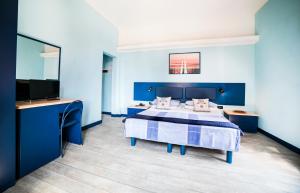 a blue bedroom with a bed and a flat screen tv at Hotel Byron in Montecatini Terme