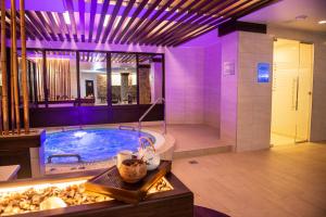 a large bathroom with a tub with purple lighting at Orion Hotel in Vladimir