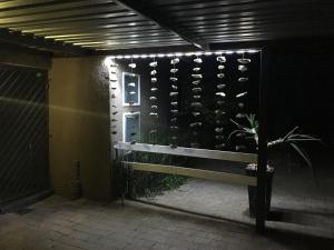 a bench in front of a wall of wine bottles at 7 Badger Street in Johannesburg