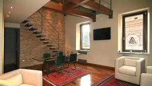 a living room with a staircase and a table and chairs at B&B La Dimora Della Zarina in Mormanno