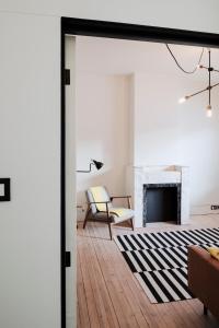 an open door into a living room with a fireplace at Behome Gent in Ghent