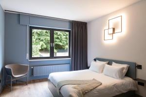 Cama o camas de una habitación en Hostellerie du Grünewald