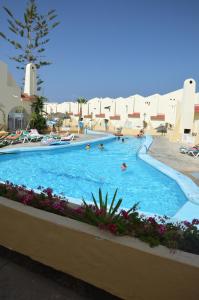 a swimming pool at a resort with people in it at Mareverde in Adeje