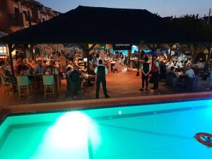 a group of people standing around a pool at a party at Sidari Waterpark in Sidari +37 photos