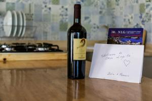 a bottle of wine sitting on a table with a note at Casa Lupita - Private Family Villa with Pool & Garden in Terracina
