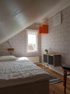 a bedroom with a white bed and a window at Mittes Rum in Alingsås