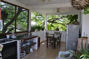a kitchen with a table and a refrigerator at Casa Ana Ruth (Bucerias, Nay.) in Bucerías