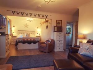 ein Wohnzimmer mit einem Bett und einem Sofa in der Unterkunft Riverside in Skeabost