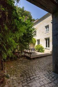 a stone patio in front of a building at La Vie Voyage in Langeais