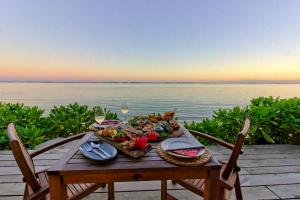 
a table with a basket of food on it at Sea Change Villas in Rarotonga
