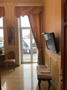 a living room with a tv and a large window at Beautiful apartment in the center of Vinnytsia in Vinnytsya