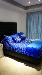 a bedroom with a bed with blue sheets and pillows at Departamento Privado 3 recamaras in Mexico City