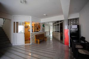 a lobby of a cocacola store with a bench in it at Hotel - Villa Lejla in Mostar