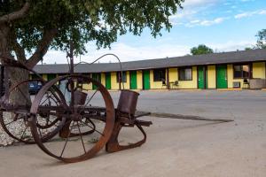 a statue of a carriage sitting in front of a building at Tower 64 Motel & RV in Trinidad