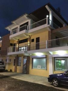 a house with a car parked in front of it at Mayon Lodging House in Legazpi