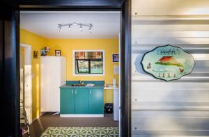 a door leading into a kitchen with a blue cabinet at Cavendish Farm in Kaiapoi