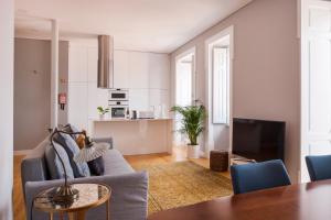 a living room with a couch and a table at Breath-Taking River & City View Stunning 3 Bedrooms & 3 Bathrooms With AC Alfama Castle district 1st Floor Apartment in Lisbon