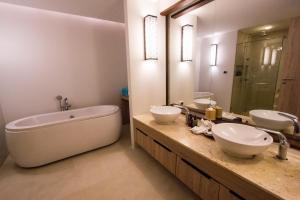a bathroom with two sinks and a bath tub at AKIRA Lipe Resort in Ko Lipe