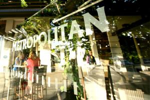 a window of a store with a sign on it at Hotel Metropolitan in Adelaide