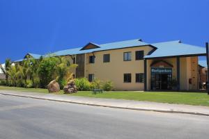 a large building on the side of a street at Ningaloo Club Backpackers in Coral Bay