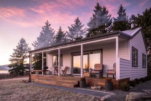 a tiny house on the beach with a sunset at Quail Rest in Twizel