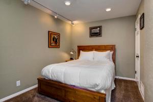 a bedroom with a large bed with a wooden headboard at Quitting Time Condo in Park City
