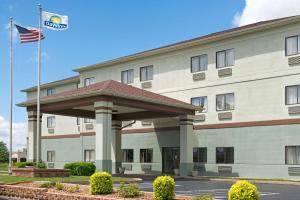 a hotel with an american flag in front of it at Days Inn by Wyndham Collinsville St Louis in Collinsville