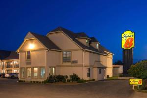 a hotel with a sign in front of a building at Super 8 by Wyndham Enid in Enid