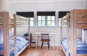 a bedroom with two bunk beds and a desk at Ljunghusen in Höllviken