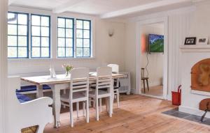 a white dining room with a table and chairs at Ljunghusen in Höllviken +17 photos