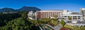 an aerial view of a hotel with mountains in the background at Pesona Alam Resort & Spa in Puncak